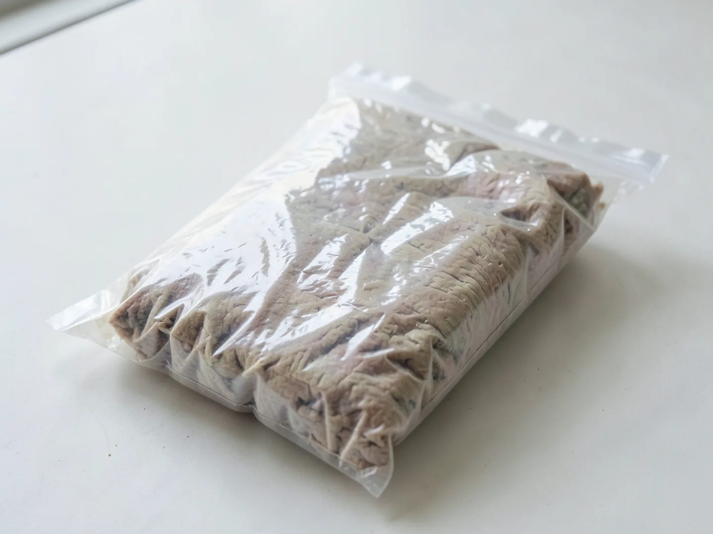 Sealed plastic laundry bags containing washed and heat-dried bedding